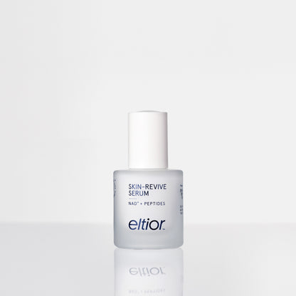 A bottle of Eltior Skin-Revive Serum with a white cap and frosted glass bottle, set against a clean white background with a soft reflection below.